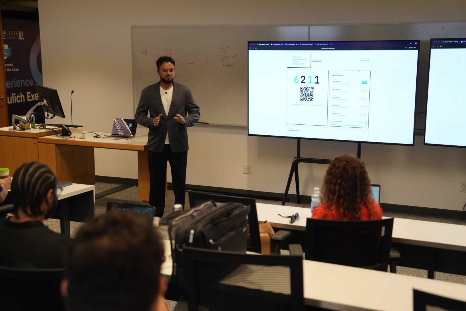 Tushar presenting the Pricing Blueprint game to Schulich PMC students with the Game Master dashboard projected